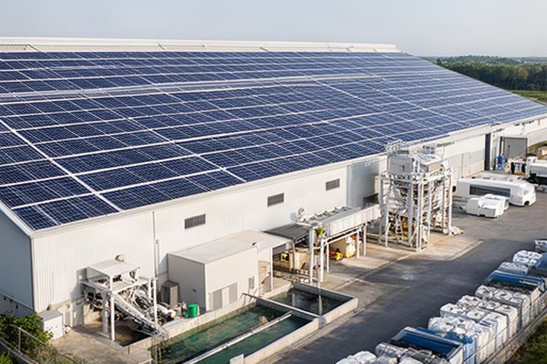 Photovoltaikanlage auf dem Werkdach über einer Betonfertigteilproduktion